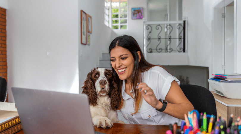 Happy lady with dog on laptop learning.